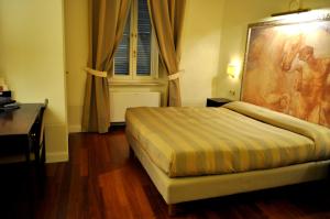 Ένα ή περισσότερα κρεβάτια σε δωμάτιο στο Albergo Sant'Emidio