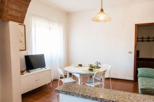 a kitchen and dining room with a table and a tv at Casa_Molara in Porto San Paolo