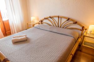 a bedroom with a bed with a towel on it at Casa_Molara in Porto San Paolo