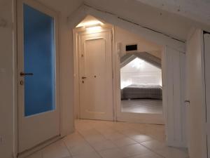an attic room with a bed and an open door at Casanova Apartment San Marco in Venice