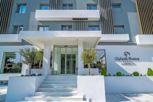 a building with a staircase in front of it at Glyfada Riviera Hotel in Athens