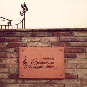 a sign for a restaurant on a brick wall at Agriturismo Bassanine in Monticelli dʼOngina