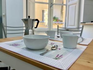 a table with cups and spoons on a napkin at Le Rondini a Roma in Rome