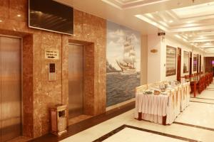 a dining room with a table and a painting of a ship at Thanh Bình Gold Hotel in Sầm Sơn