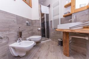 a bathroom with a sink and a toilet and a shower at Hotel Sauze in Sauze dʼOulx