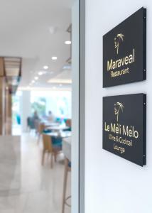 a sign on the door of a restaurant at Glyfada Riviera Hotel in Athens