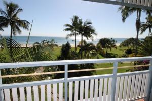 a view from a balcony of a beach with palm trees at Moreton Island Villas and Apartments in Tangalooma