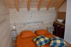a bedroom with a bed with two pillows on it at chalet perché in LʼHuez