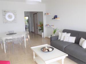 a living room with a couch and a table at Escape to the French Riviera in Villefranche-sur-Mer