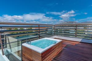 a hot tub on the balcony of a building at Glyfada Riviera Hotel in Athens