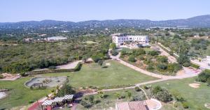 an aerial view of a park with a large building at Quinta dos Poetas Nature Hotel & Apartments in Olhão