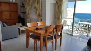 a dining room table and chairs with a view of the ocean at vistas al mar in Torre del Mar