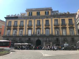 a group of people standing outside of a large building at Domus Zapata in Naples