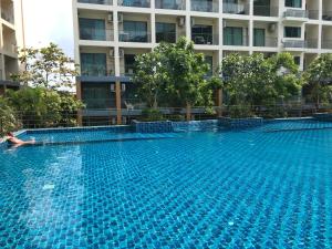 a swimming pool in front of a building at Laguna Beach Resort 2 in Jomtien Beach