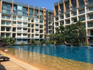 a swimming pool in front of some apartment buildings at Laguna Beach Resort 2 in Jomtien Beach
