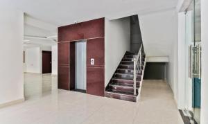 a hallway with a staircase in a building at Treebo Blu Orchid in Bengaluru