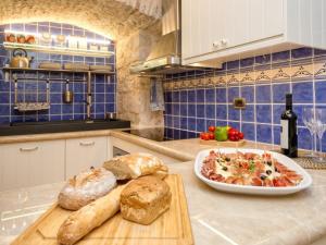 a kitchen with bread and a plate of food on a counter at Villa Varda - Villa Latica in Hvar