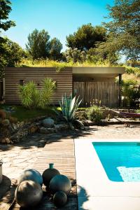
a patio with a pool and a lawn chair at Chambre d'hôtes Clos du Petit Jésus in Cassis

