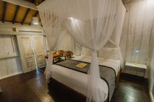 a bedroom with a bed with a canopy at Green Taman Ubud by Prasi in Ubud +31 photos