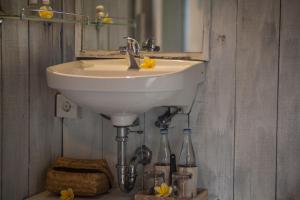 a white sink in a bathroom with a mirror at Green Taman Ubud by Prasi in Ubud +30 photos