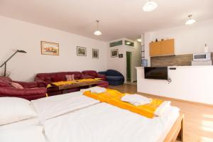 a living room with a white bed and a couch at Apartment Jasna in Mostar