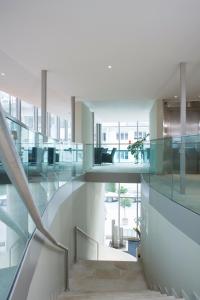 an open staircase in a building with glass walls at Engimatt City & Garden Hotel in Zurich
