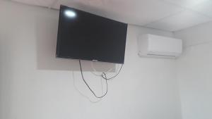 a flat screen tv hanging on a wall at Hostal Villa Cecilia in Villavieja
