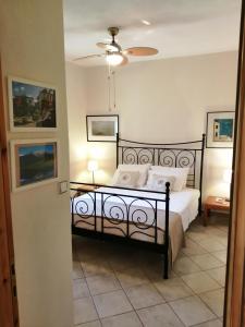a bedroom with a black bed with white pillows at Family House by the Sea in Nikiti