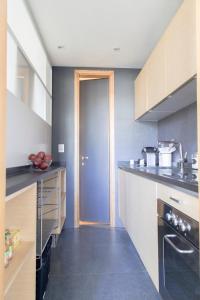 a kitchen with a sink and a door in it at Wonderful Brera flat in Milan