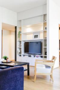 a living room with a tv and a table at Wonderful Brera flat in Milan