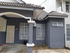 a blue and white house with a door at Anis Homestay Gua Musang in Gua Musang