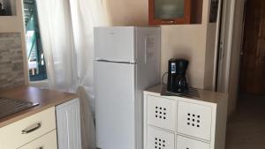 a kitchen with a white refrigerator and a coffee maker at Mansarda 5 terre in Monterosso al Mare