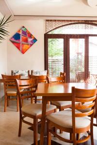 uma sala de jantar com mesas e cadeiras e um papagaio na parede em Silistar Hotel em Rezovo
