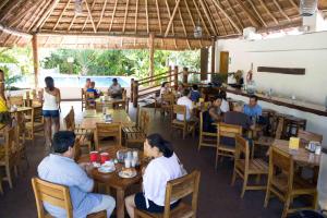 people sitting at tables in a restaurant at Sotavento Hotel & Yacht Club in Cancún