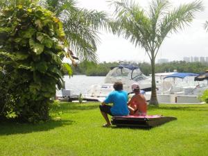 a man and a woman sitting on a boat in the water at Sotavento Hotel & Yacht Club in Cancún
