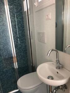 a bathroom with a sink and a toilet and a shower at B&B Porta Girone in Civitanova Alta