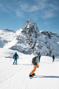 a group of people skiing on a snow covered mountain at Anayet Sweet Home in Formigal