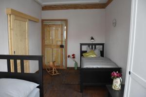 a bedroom with a bed and a door to a room at Ferienwohnung Veste Coburg in Bad Rodach
