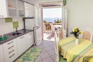 a small kitchen with a table and a balcony at Villa Sarah in Selca