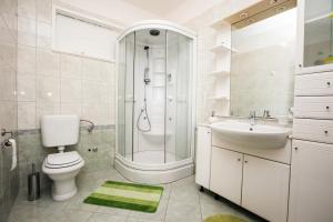 a bathroom with a shower and a toilet and a sink at Villa Sarah in Selca +67 photos