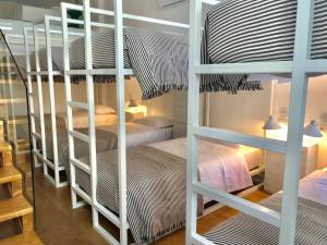 a room with two bunk beds and two beds at HOSTEL ALAMEDA EXCLUSIVE HOUSE in Faro +44 photos