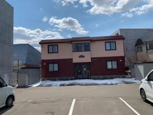 a parking lot in front of a building at Sejour Toyohirakoen in Sapporo