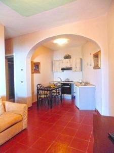 a kitchen and a living room with a table and chairs at Borgo degli Aranci in San Giuliano Terme