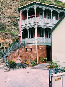 a large building with a staircase in front of it at Apartment Botanikuri 15 in Tbilisi City