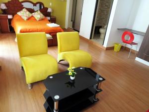 a bedroom with two chairs and a bed and a table at Reggio Green Hotel in Abancay