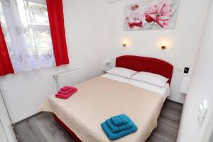 a small bedroom with a bed with two towels on it at Apartment Ivan in Kastel Sucurac