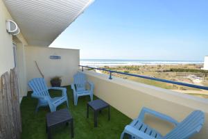 balcone con sedie blu e vista sulla spiaggia di APPT T3 Rêve d'Océan les pieds dans l'eau a Lacanau
