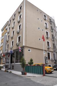 a building with a yellow car parked in front of it at Grand Reis Hotel in Istanbul