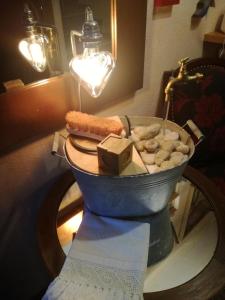 a table with a bucket of food and a candle at Hotel Filey in Antey-Saint-André