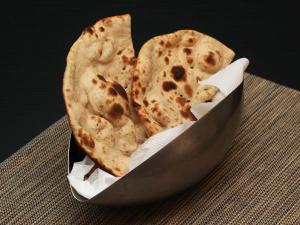 two slices of pizza in a container on a table at The Grand Vikalp By Saga Hotels in New Delhi